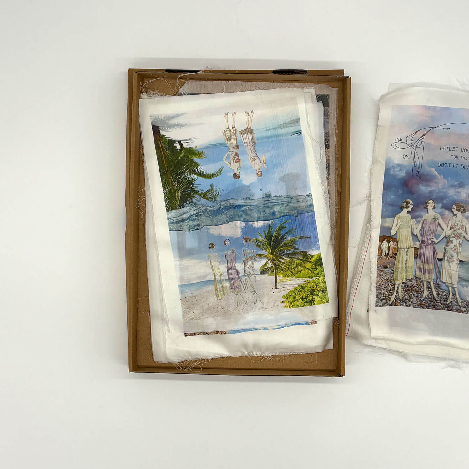 A studio photo of a designer bag and a publication printed on textile