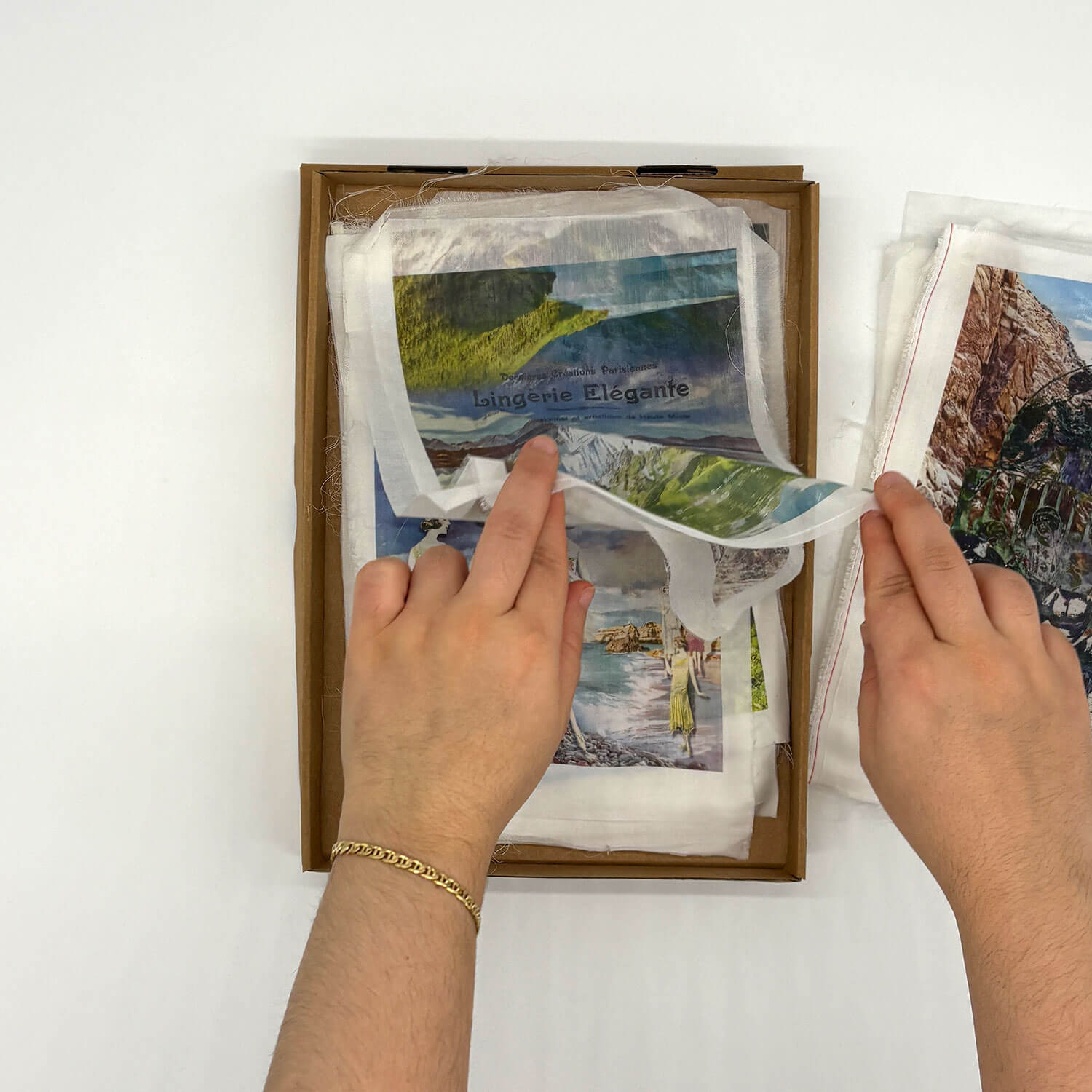 A studio photo of a designer bag and a publication printed on textile