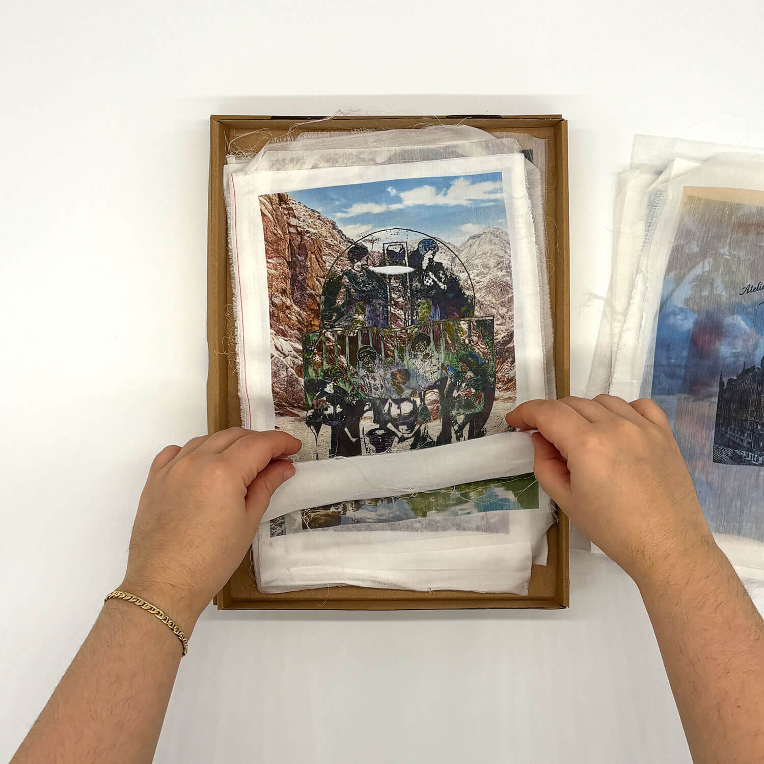A studio photo of a designer bag and a publication printed on textile
