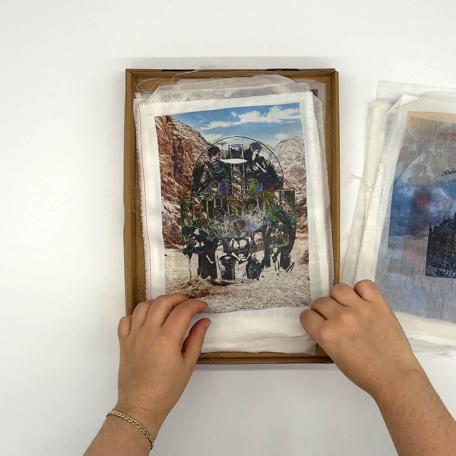A studio photo of a designer bag and a publication printed on textile