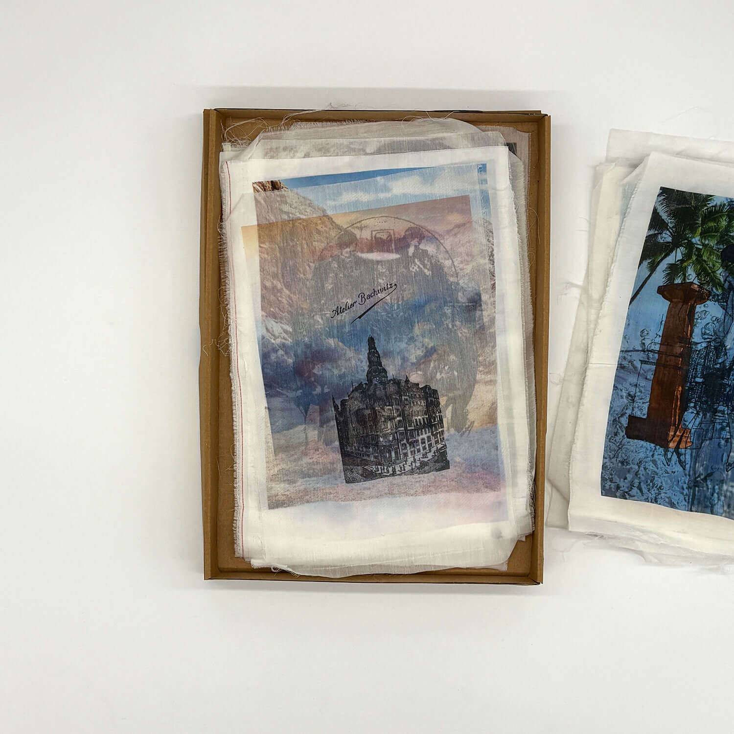 A studio photo of a designer bag and a publication printed on textile