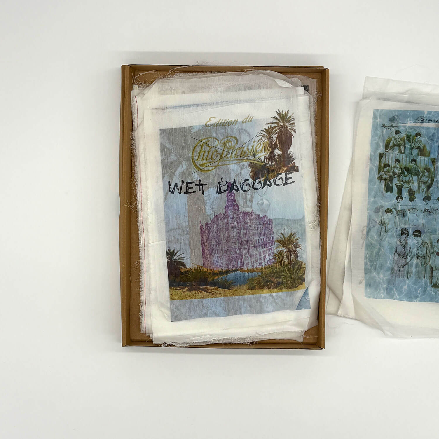 A studio photo of a designer bag and a publication printed on textile