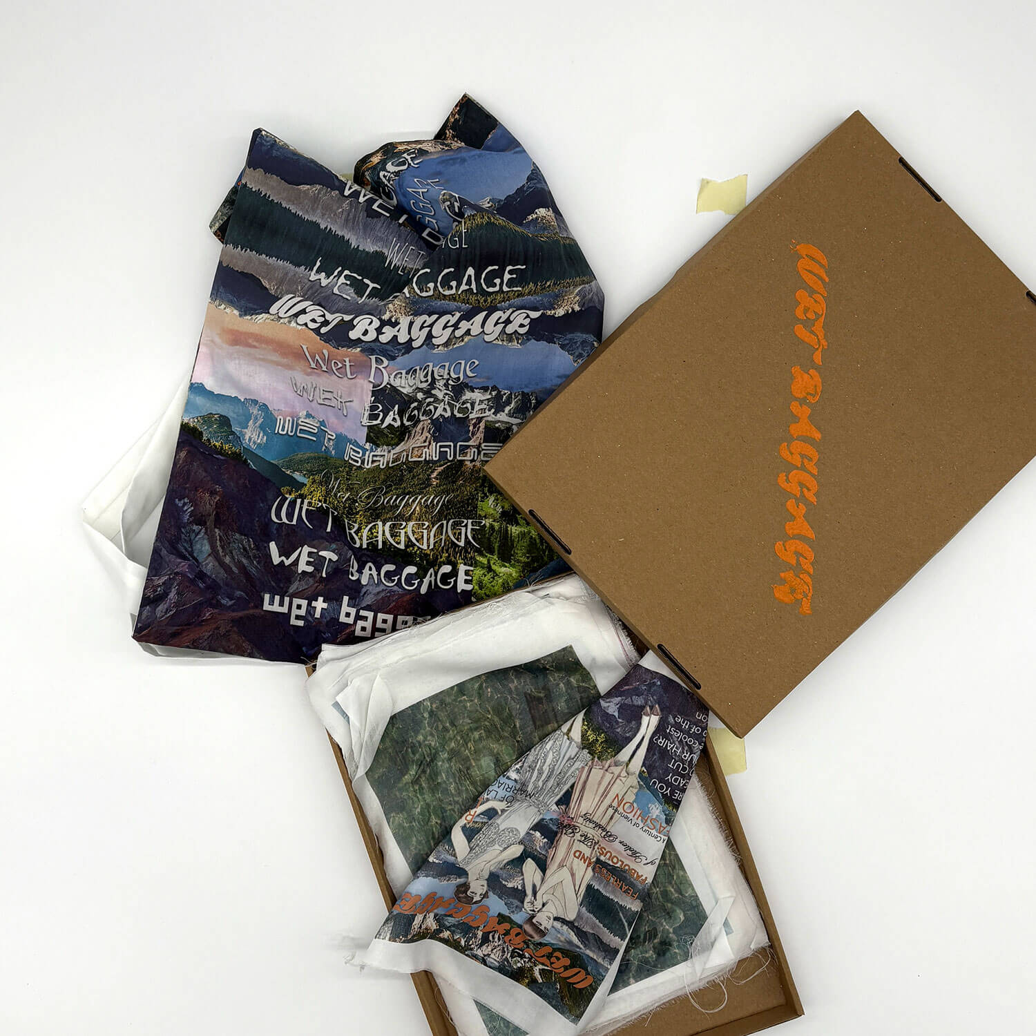 A studio photo of a designer bag and a publication printed on textile