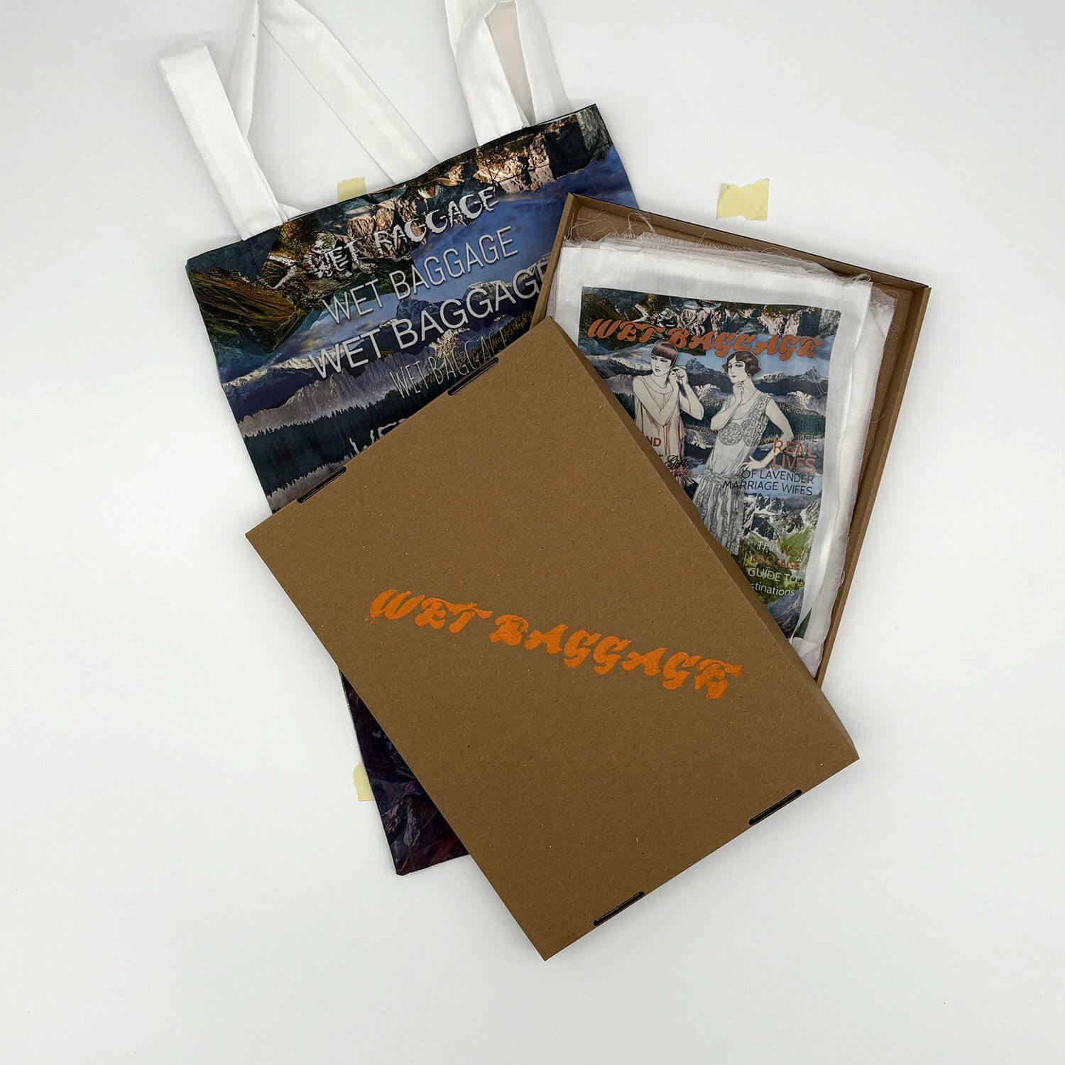 A studio photo of a designer bag and a publication printed on textile