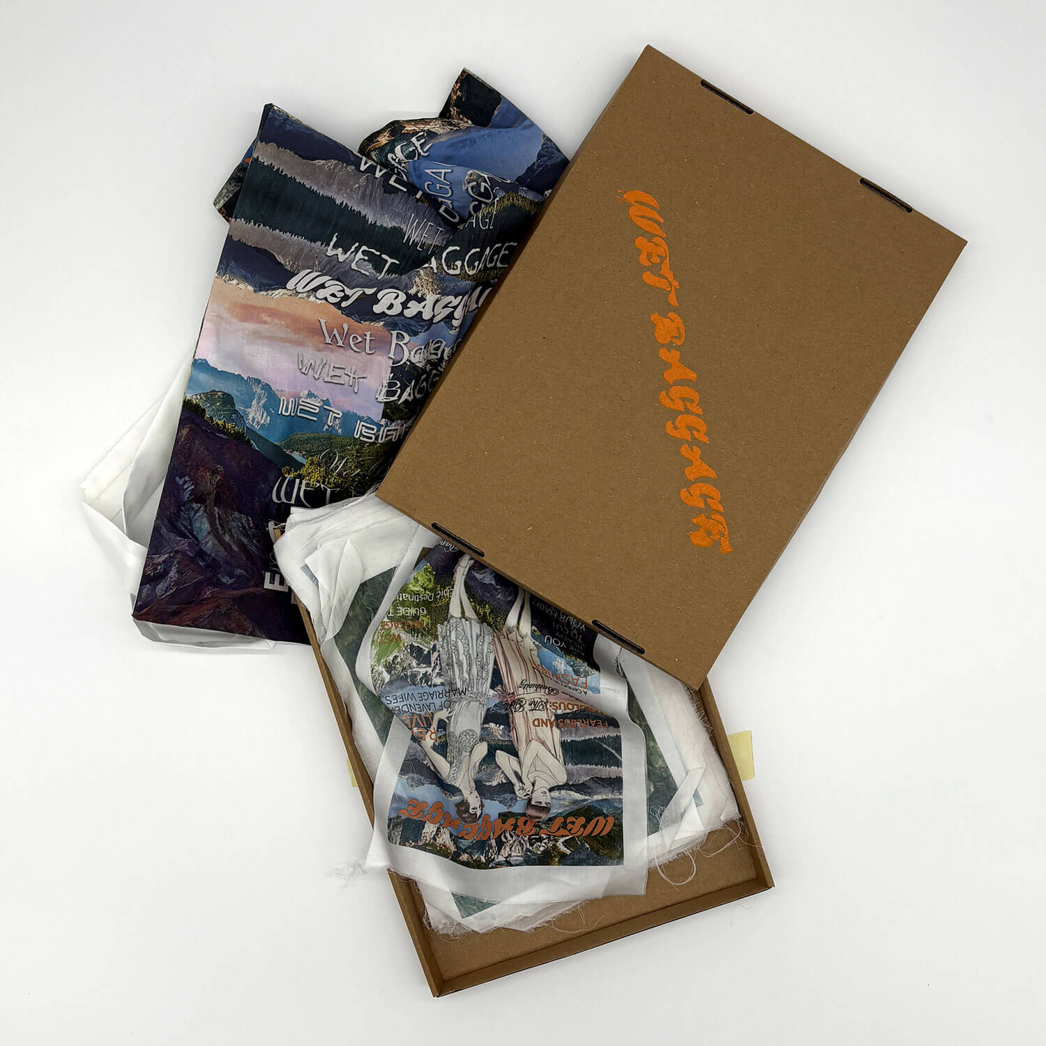 A studio photo of a designer bag and a publication printed on textile