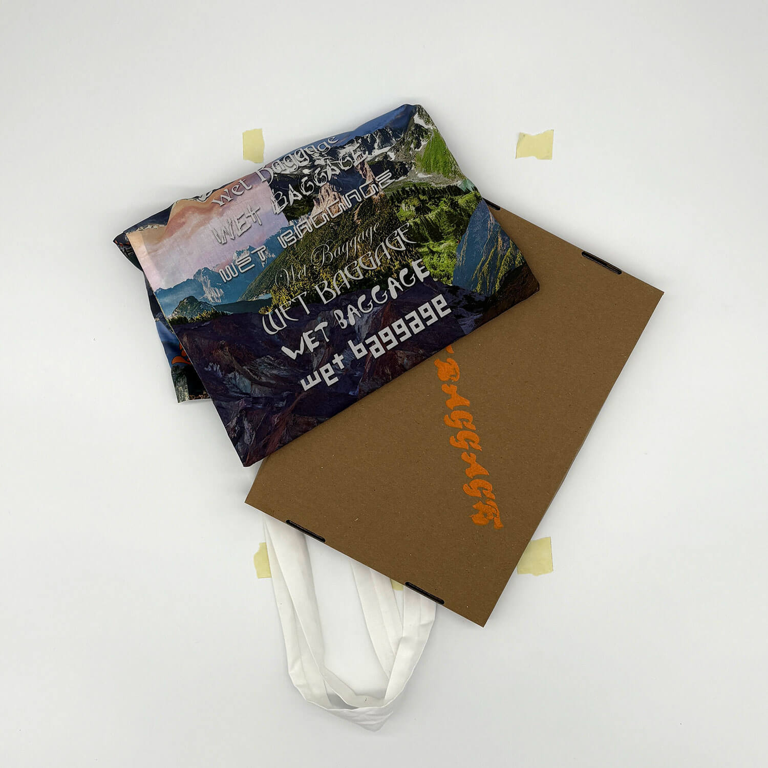 A studio photo of a designer bag and a publication printed on textile