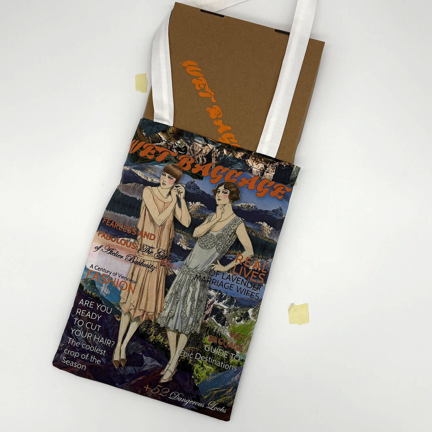 A studio photo of a designer bag and a publication printed on textile