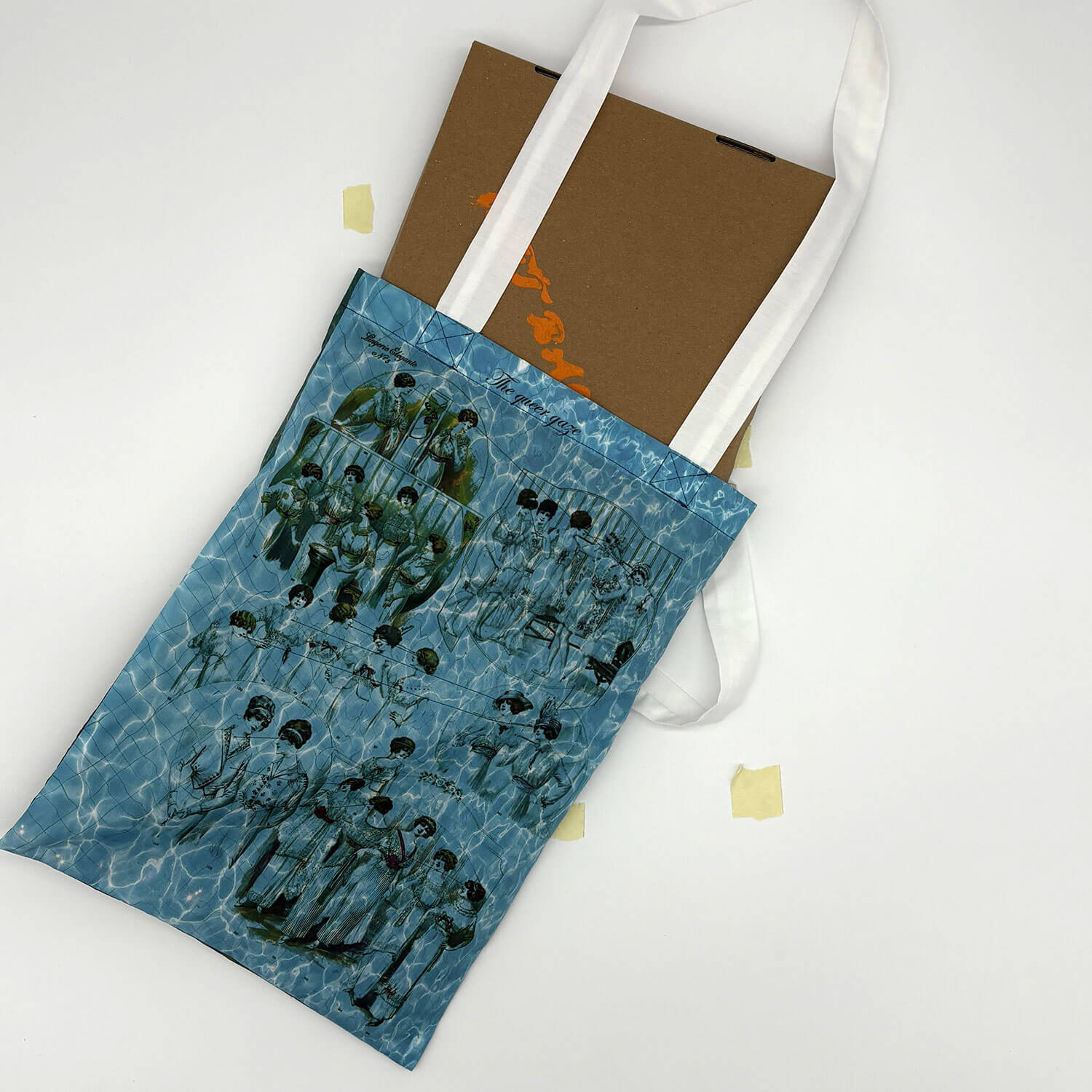 A studio photo of a designer bag and a publication printed on textile