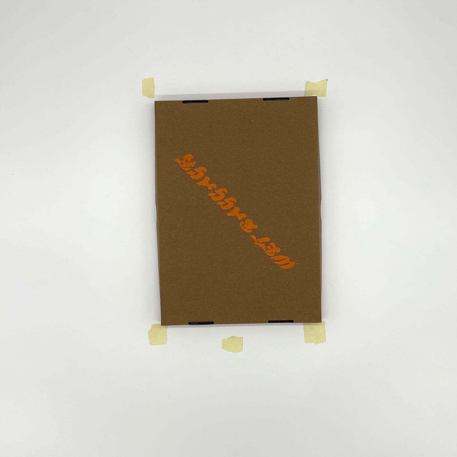 A studio photo of a designer bag and a publication printed on textile