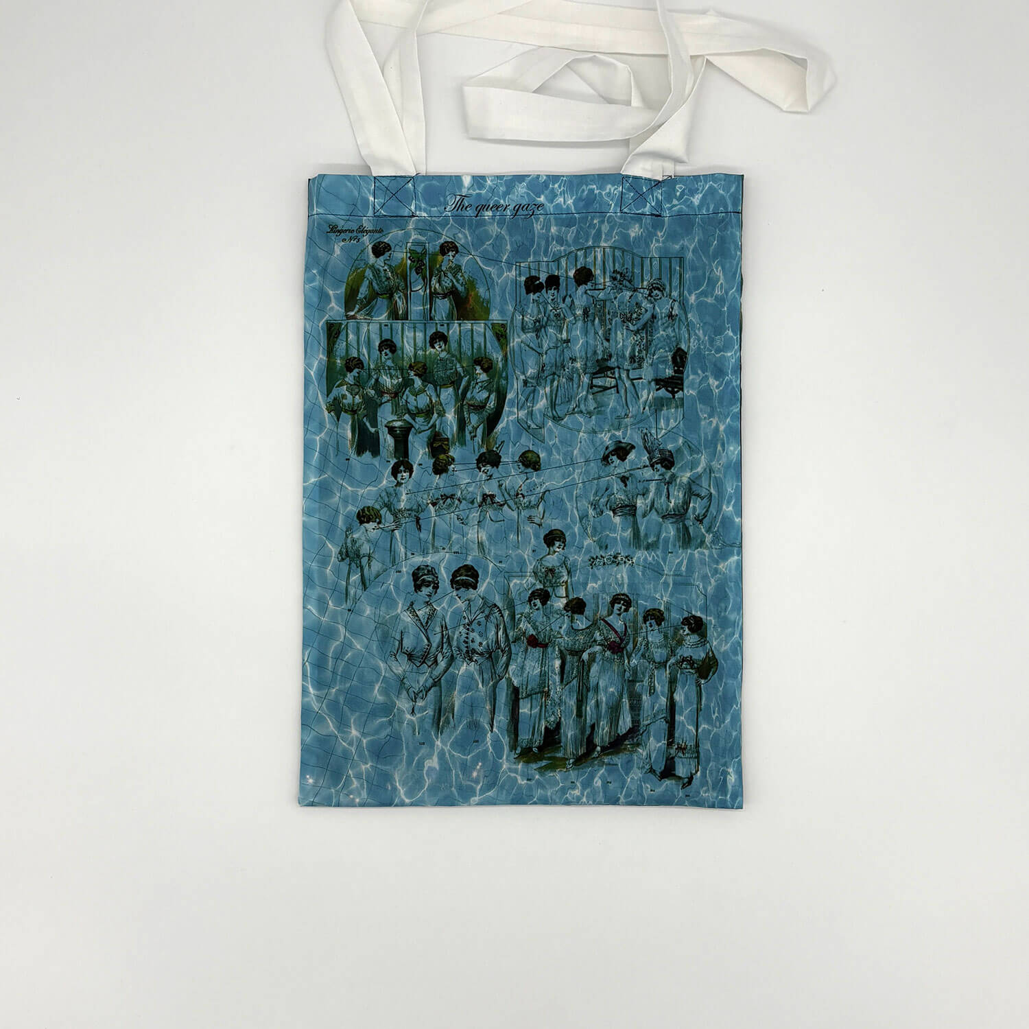 A studio photo of a designer bag and a publication printed on textile