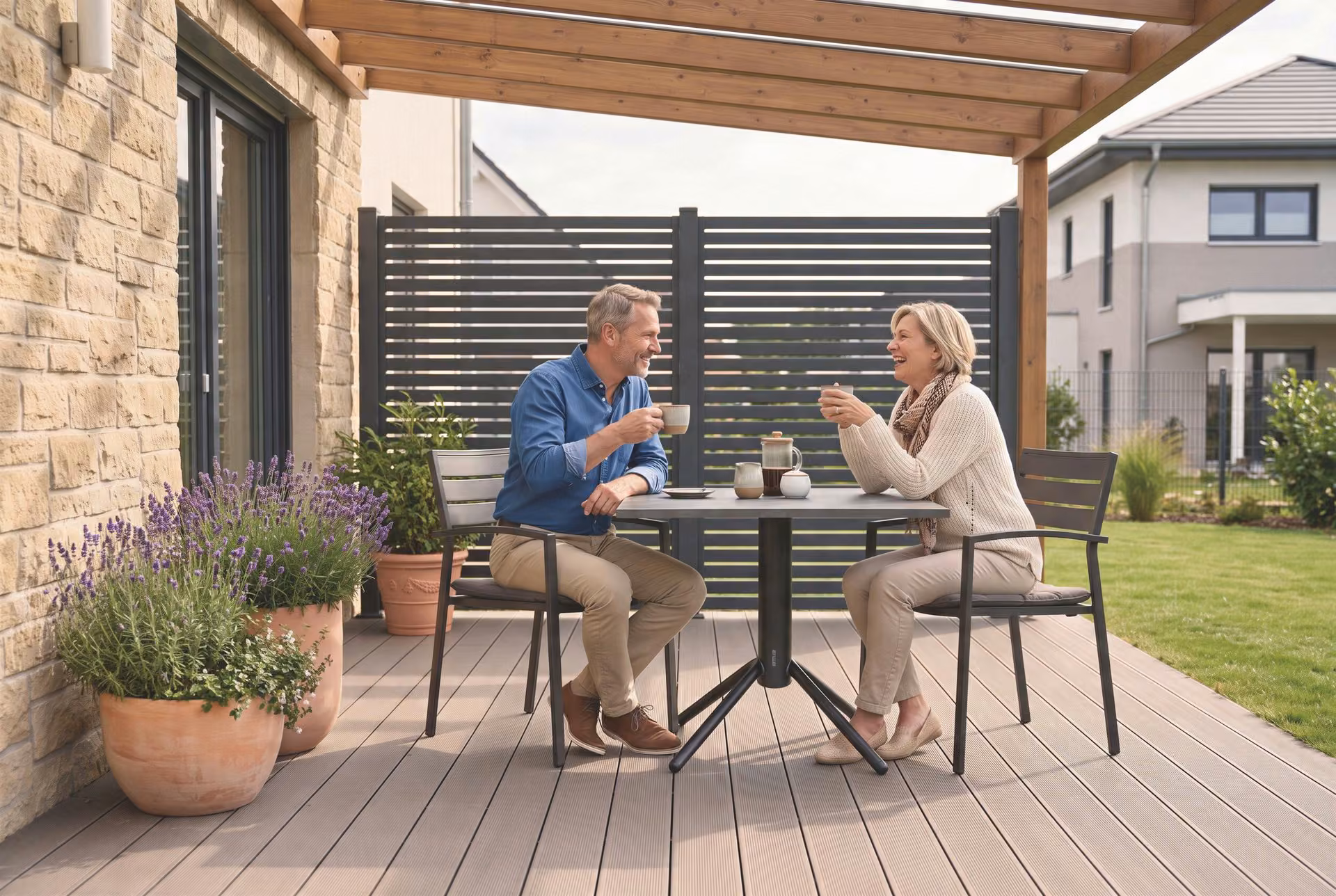 VERSA Tischgestell anthrazit mit KETTERIO Tischplatte und ROUEN Stapelsesseln auf der Terrasse