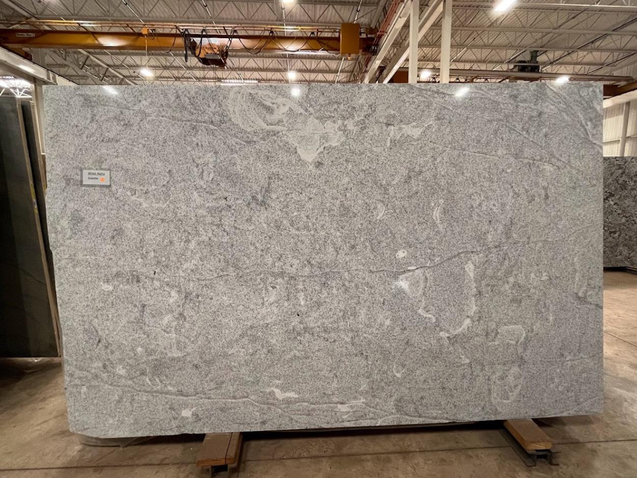 White Alpha neutral granite slab with soft gray detailing