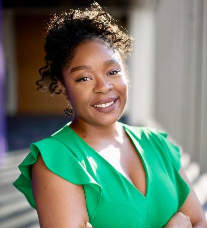 Headshot of Alycia Washington, a Black woman with a curly updo wearing a green blouse.