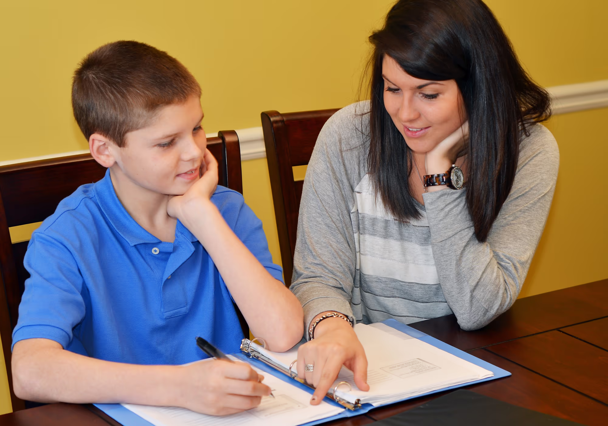 Child receiving one-to-one learning support from a specialist