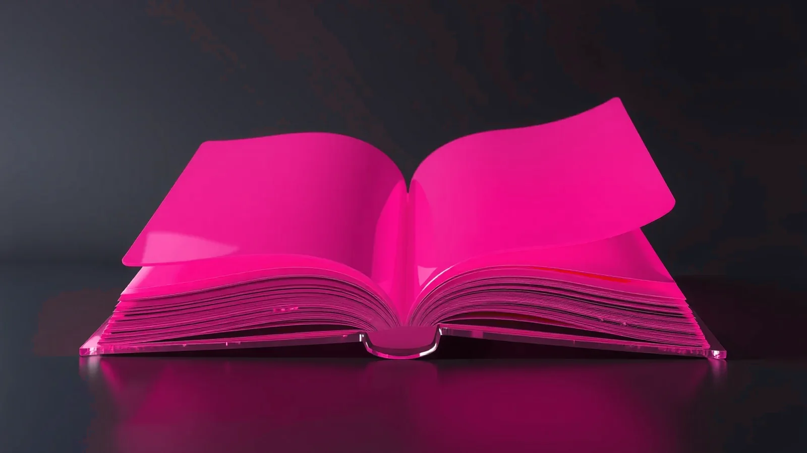 Open book made of pink glass on a dark surface.