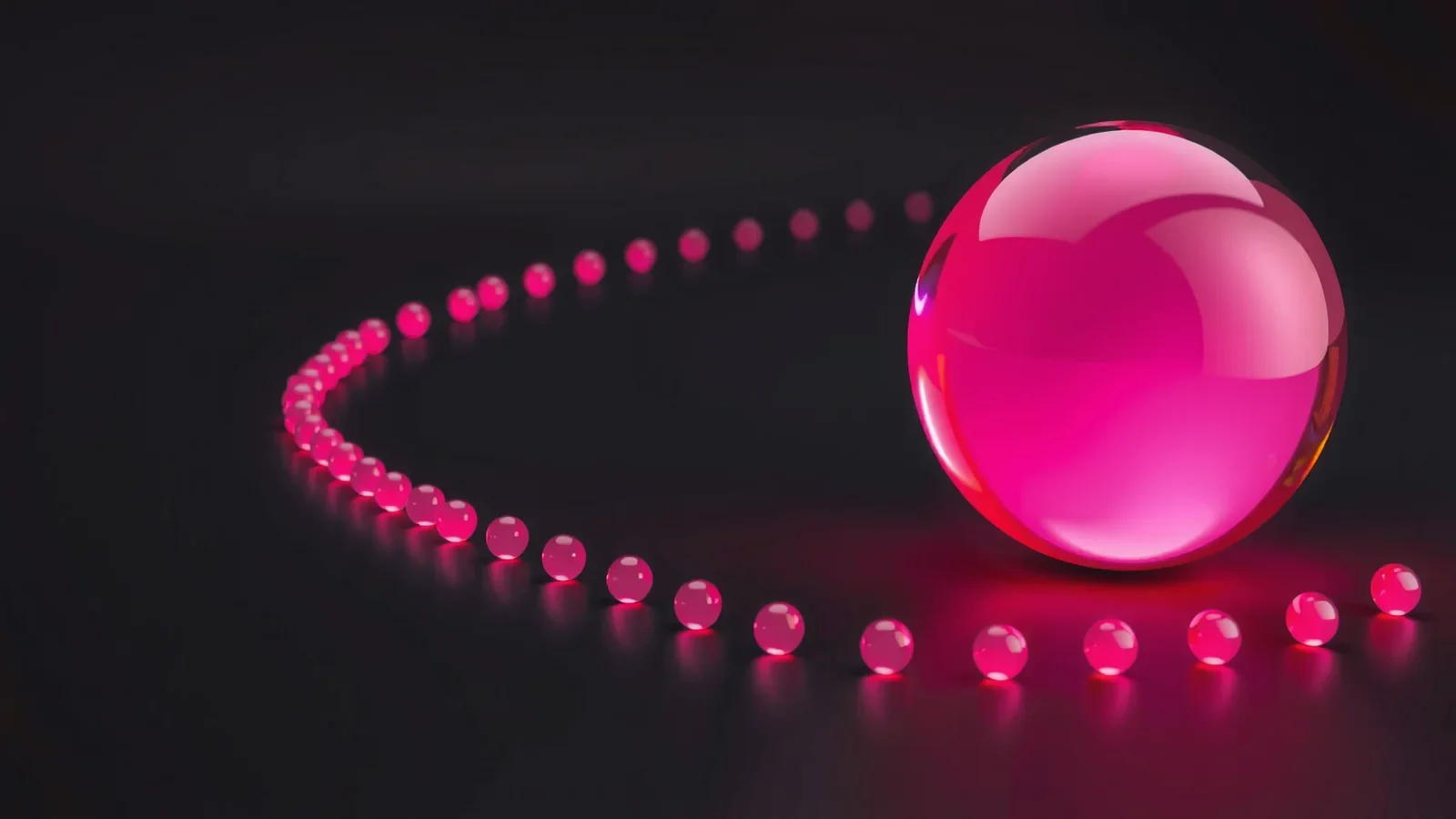 Large pink glass sphere at the end of a curved trail of glowing beads.