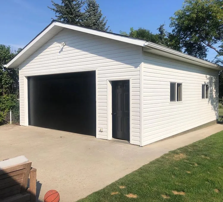 White garage with black garage door painted by Kennedy Coatings, Edmonton