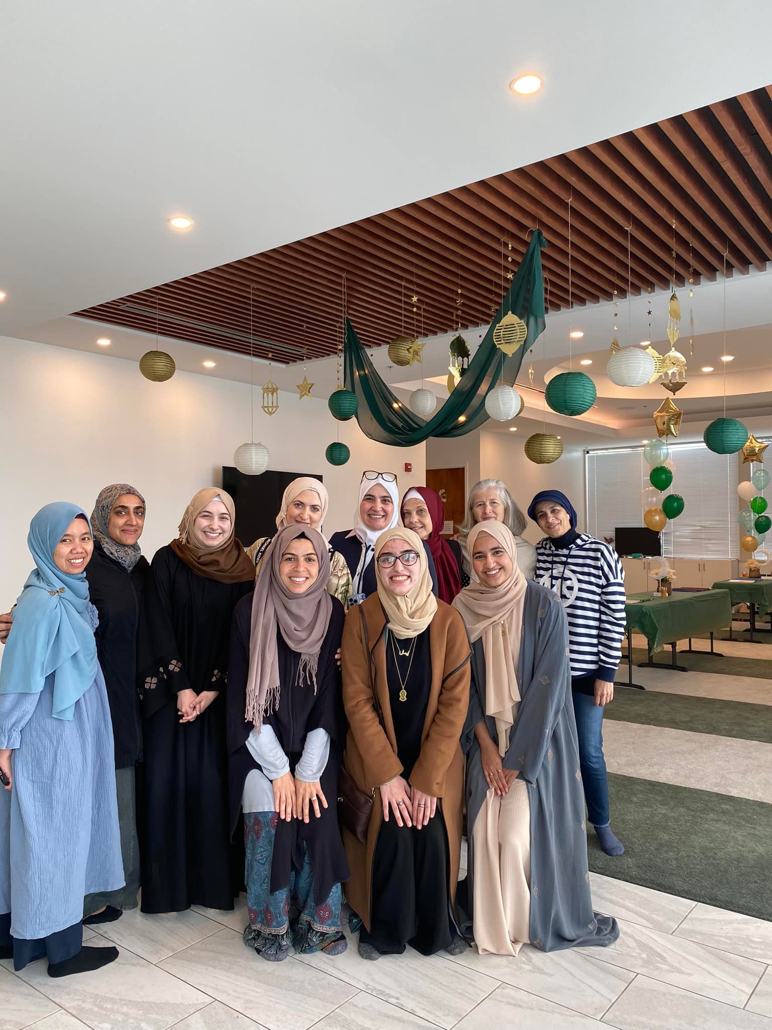 A group of women standing together from Mozaic, smiling.