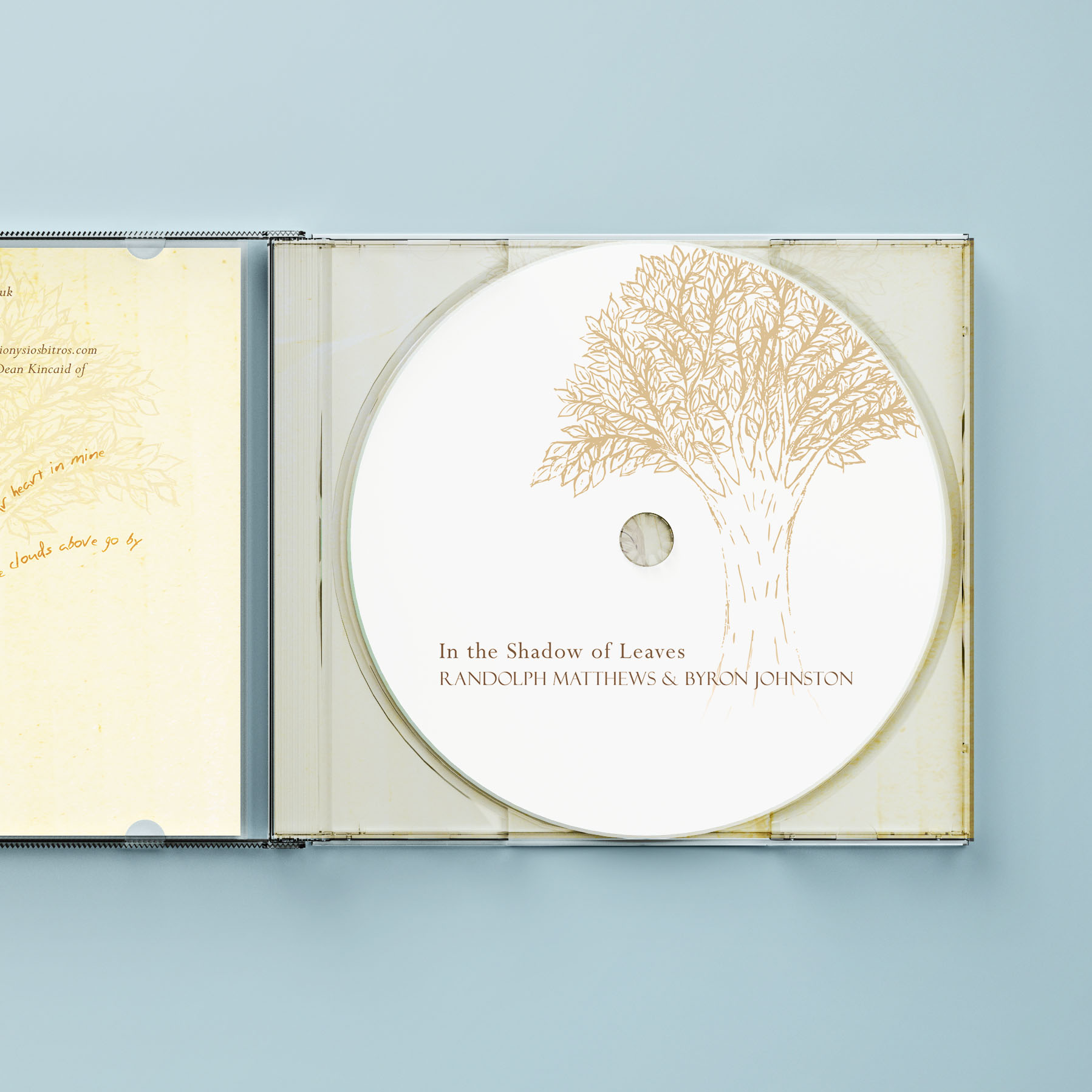 Open CD case showing the white CD with illustrated tree in the tray.