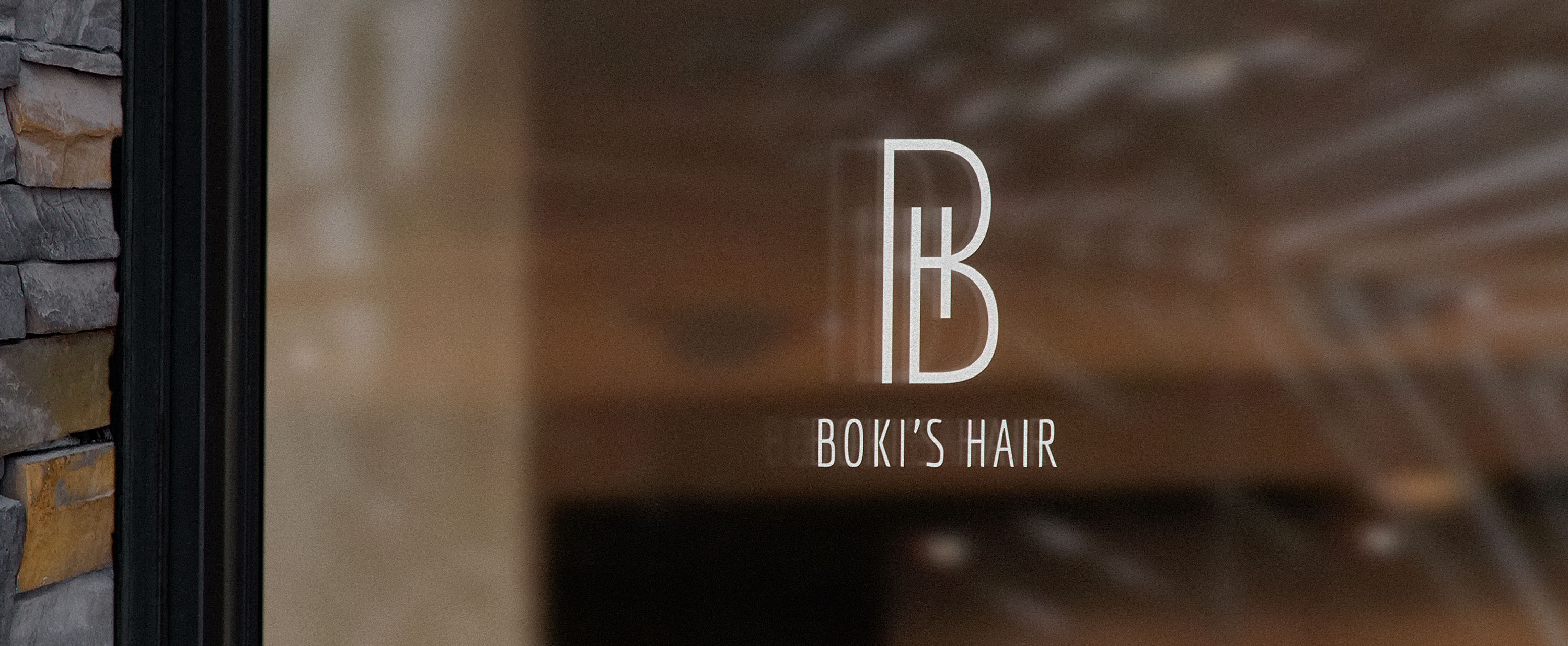 Image of the white BH monogram logo displayed on a window.