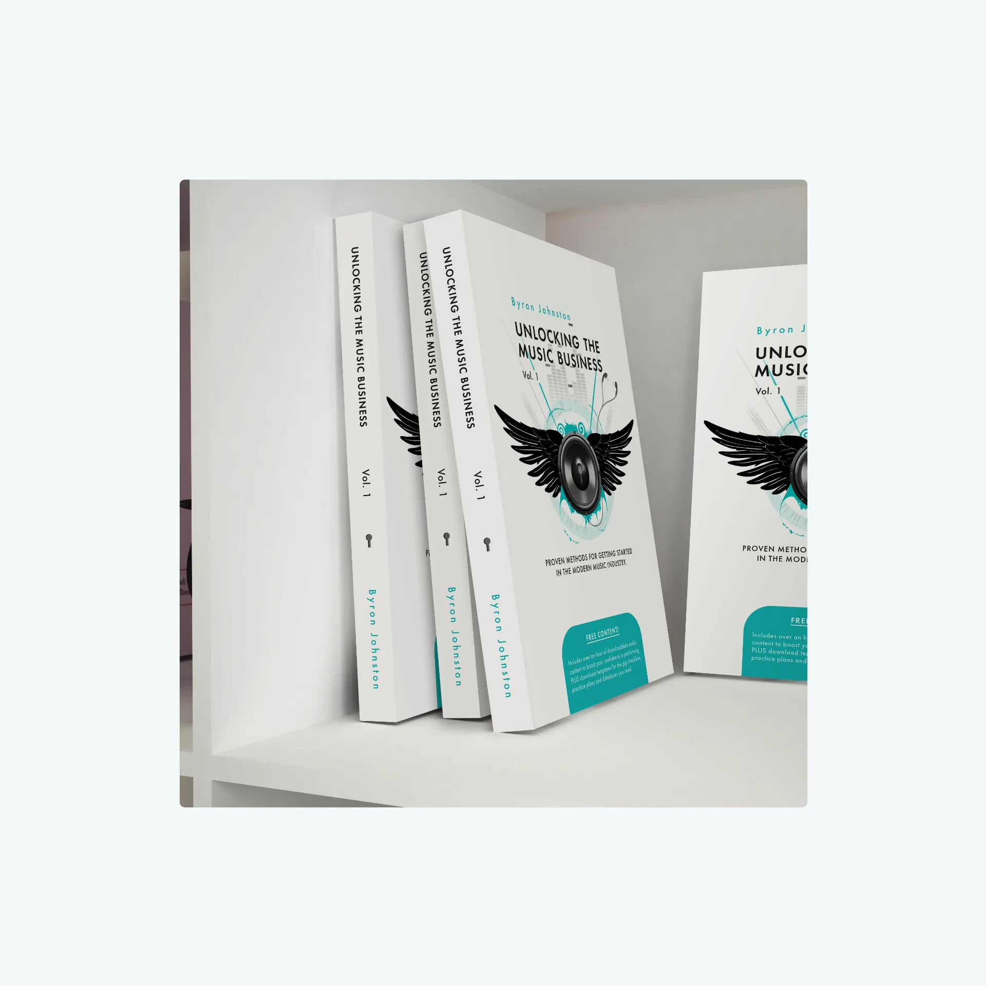 Photo showing white books on a shelf, with two covers visible featuring a digitally illustrated speaker with wings, surrounded by musical elements like a digitiser, headphones, and musical notes.