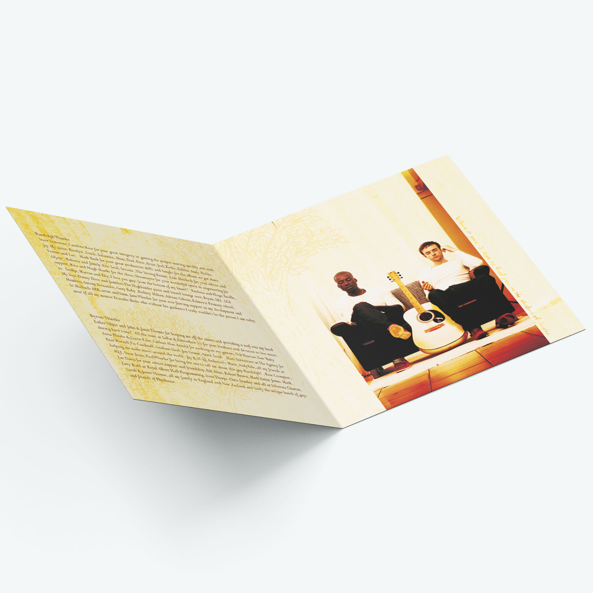 Open CD booklet on a surface showing artist thanks and a photo of Randolph Matthews and Byron Johnston sitting on a sofa with their eyes closed, a guitar between them, in earthy tones.