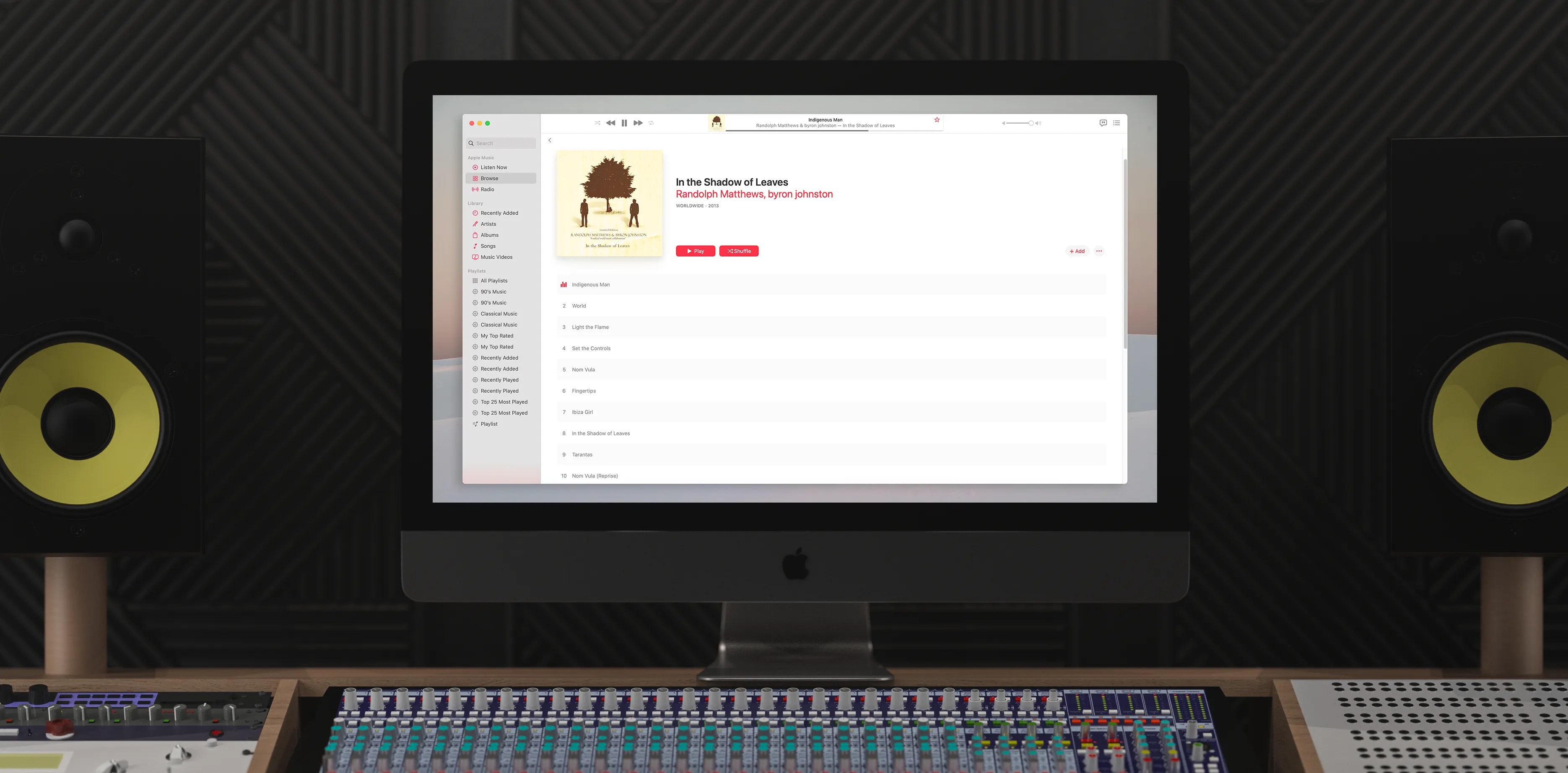 iMac set up in a music studio displaying In the Shadow of Leaves on the iTunes interface.