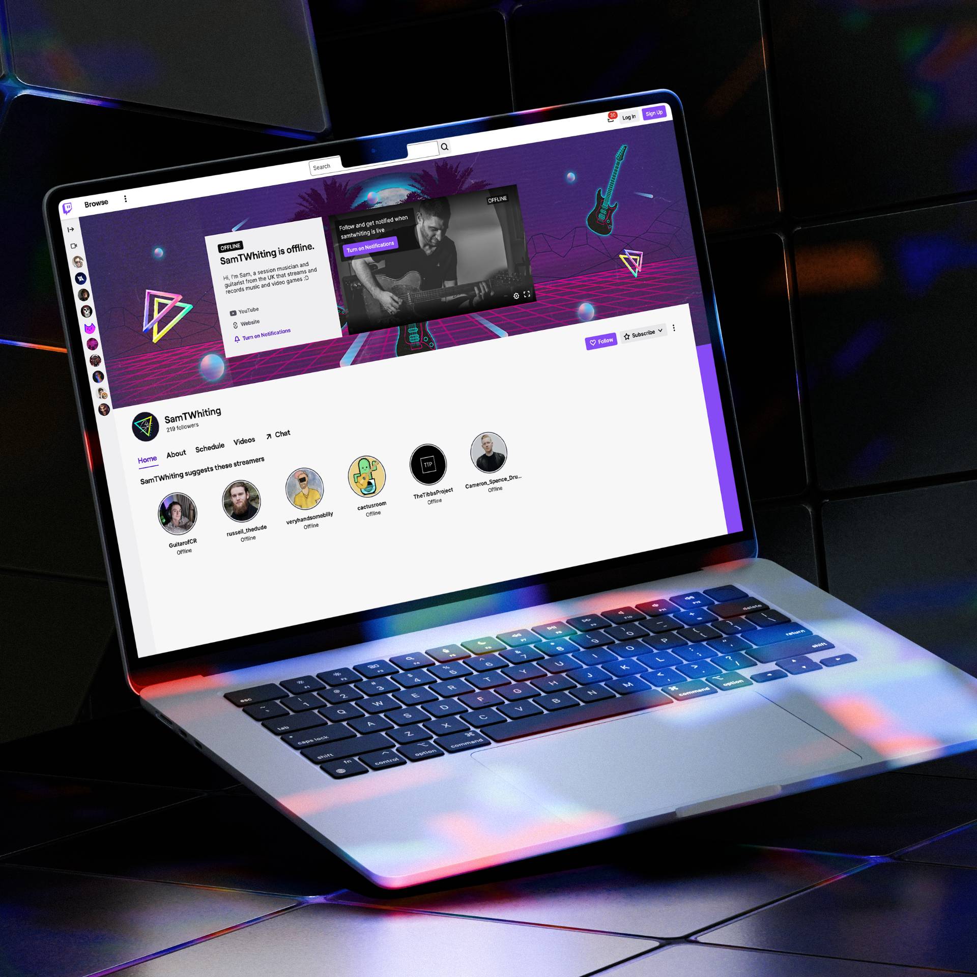 MacBook displaying the STW Music social media banner on Sam’s Twitch profile page.