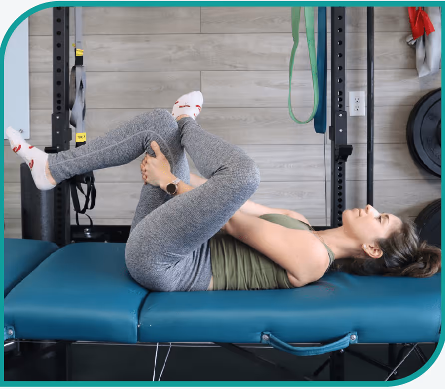 Female laying down completing piriformis stretch