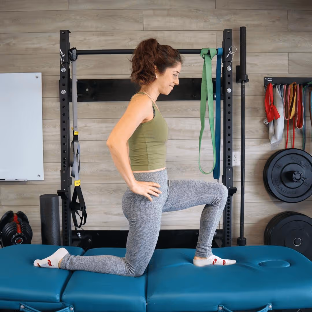 A girl kneeling in a half lunge position and rocking forwards