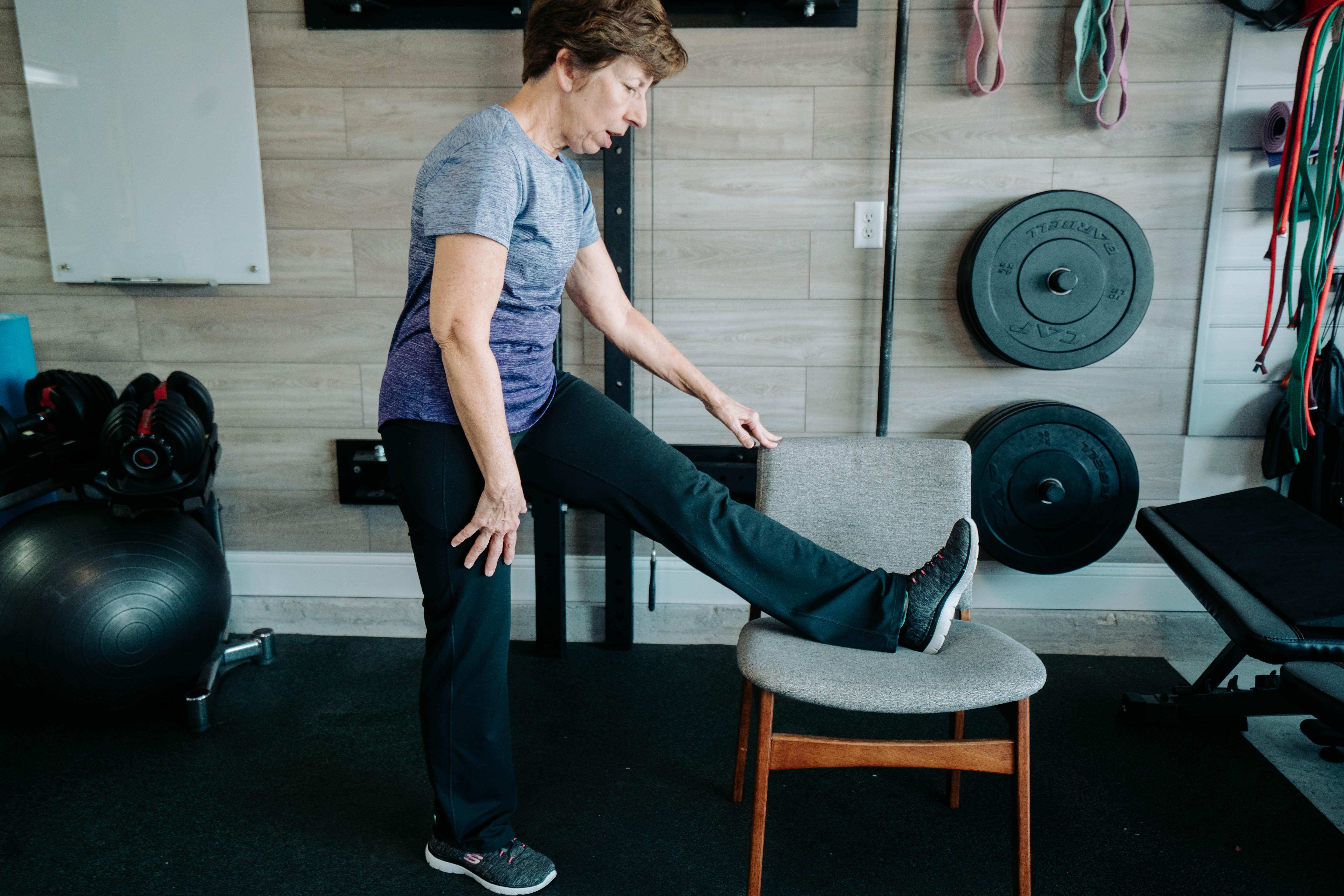 Older Women Doing A Standing Hamstring Stretch