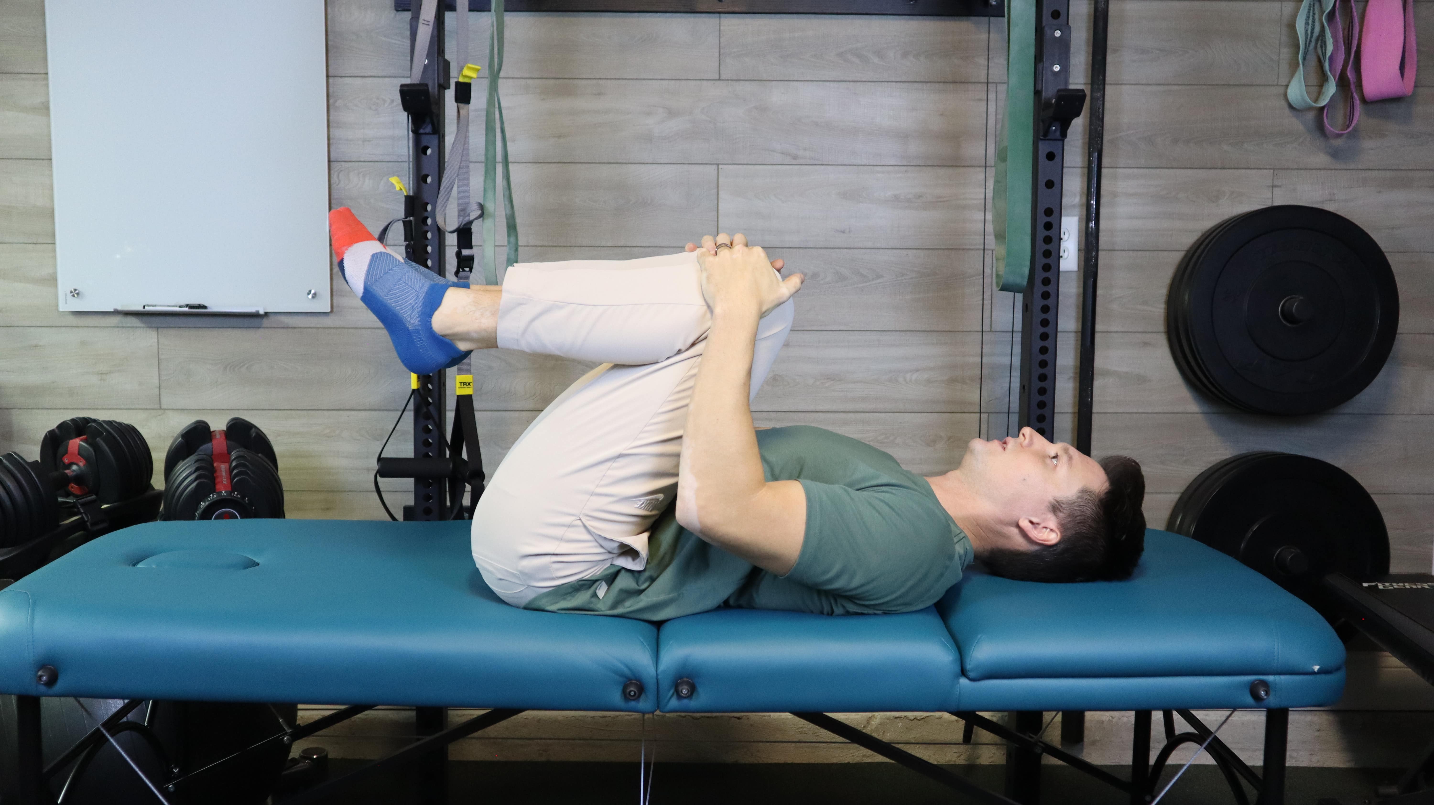 Man Doing A Knees to Chest Stretch for Glutes
