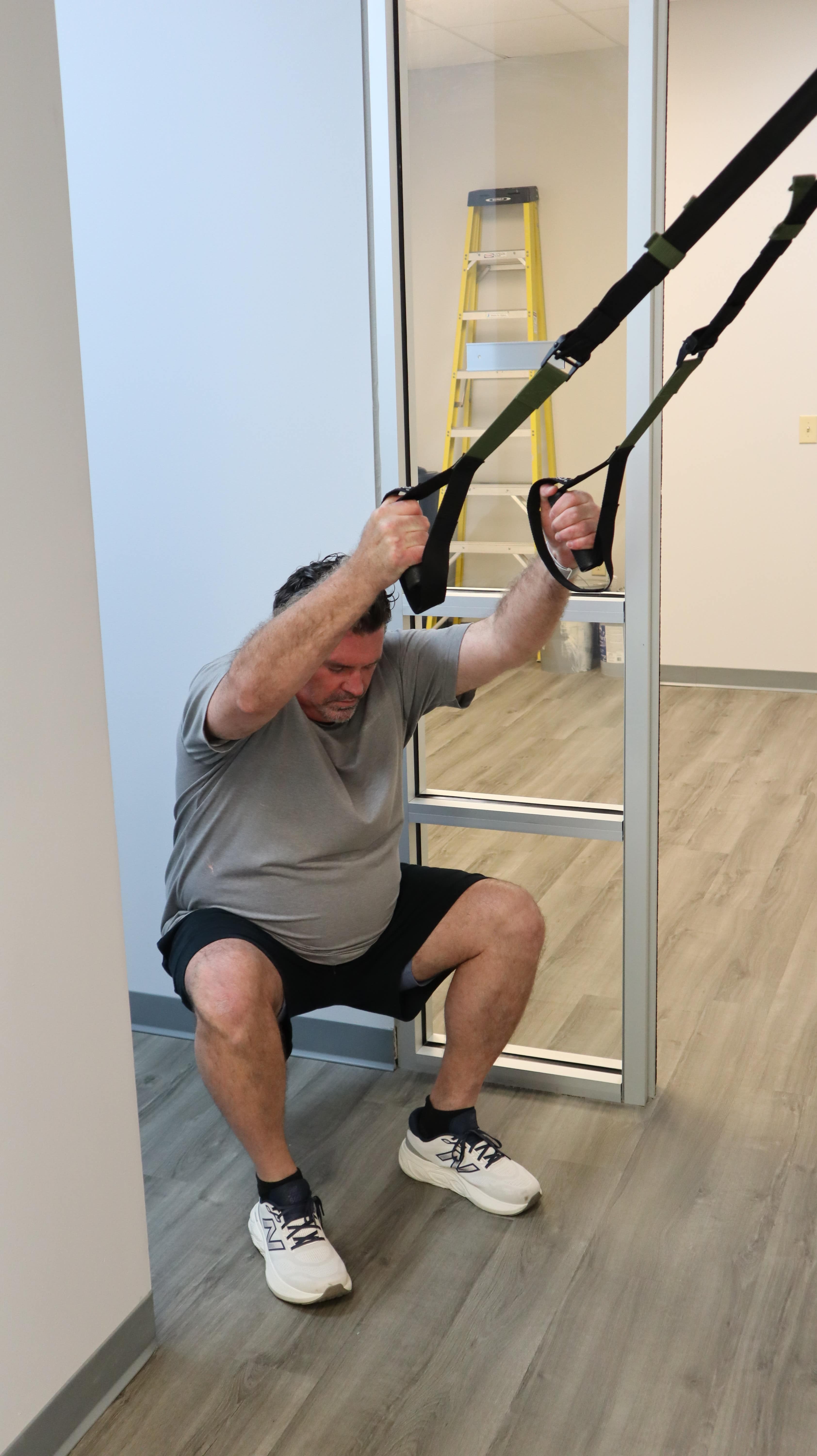 Man performing TRX squat