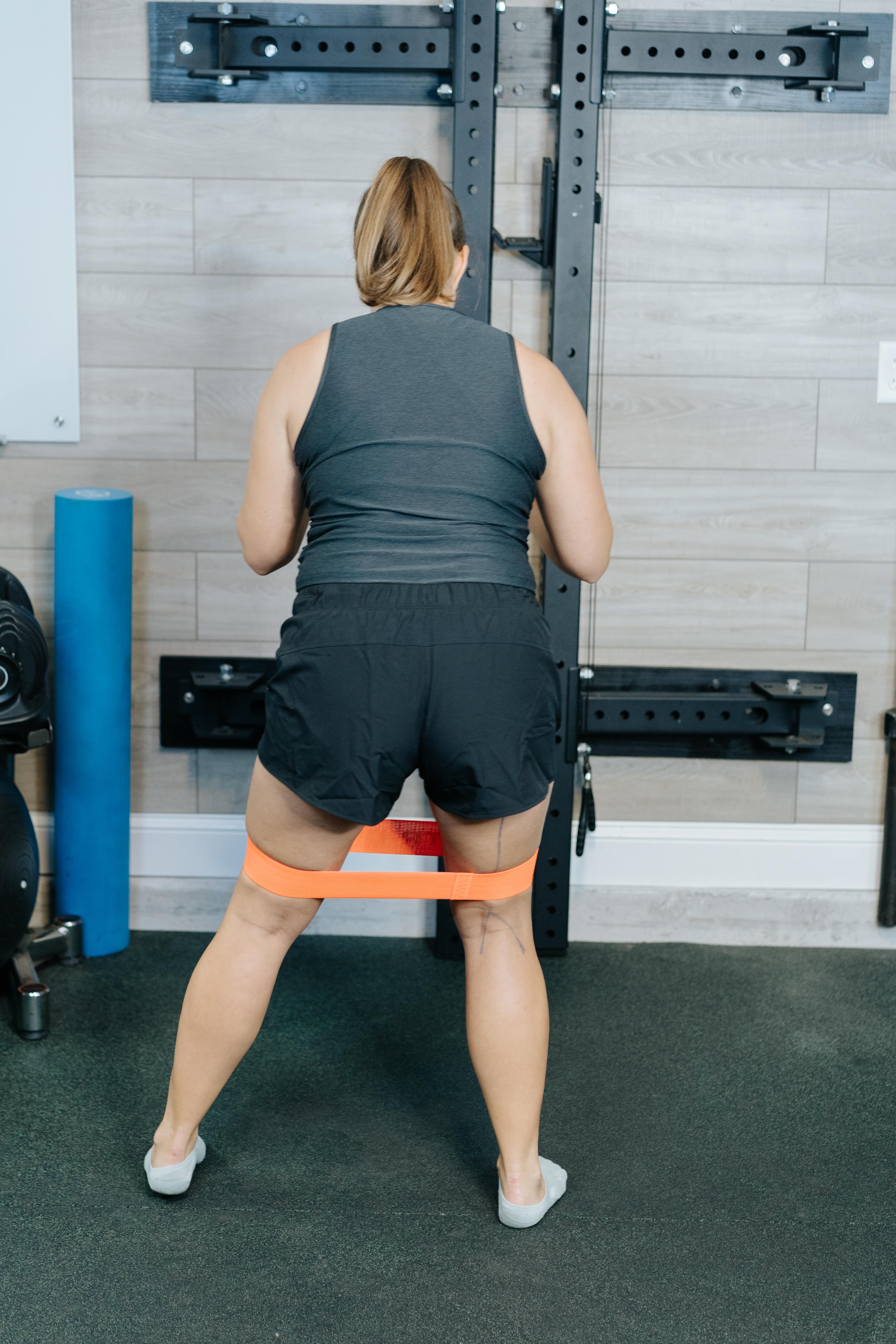 Women demonstrating side step with strap stepping out for stretch