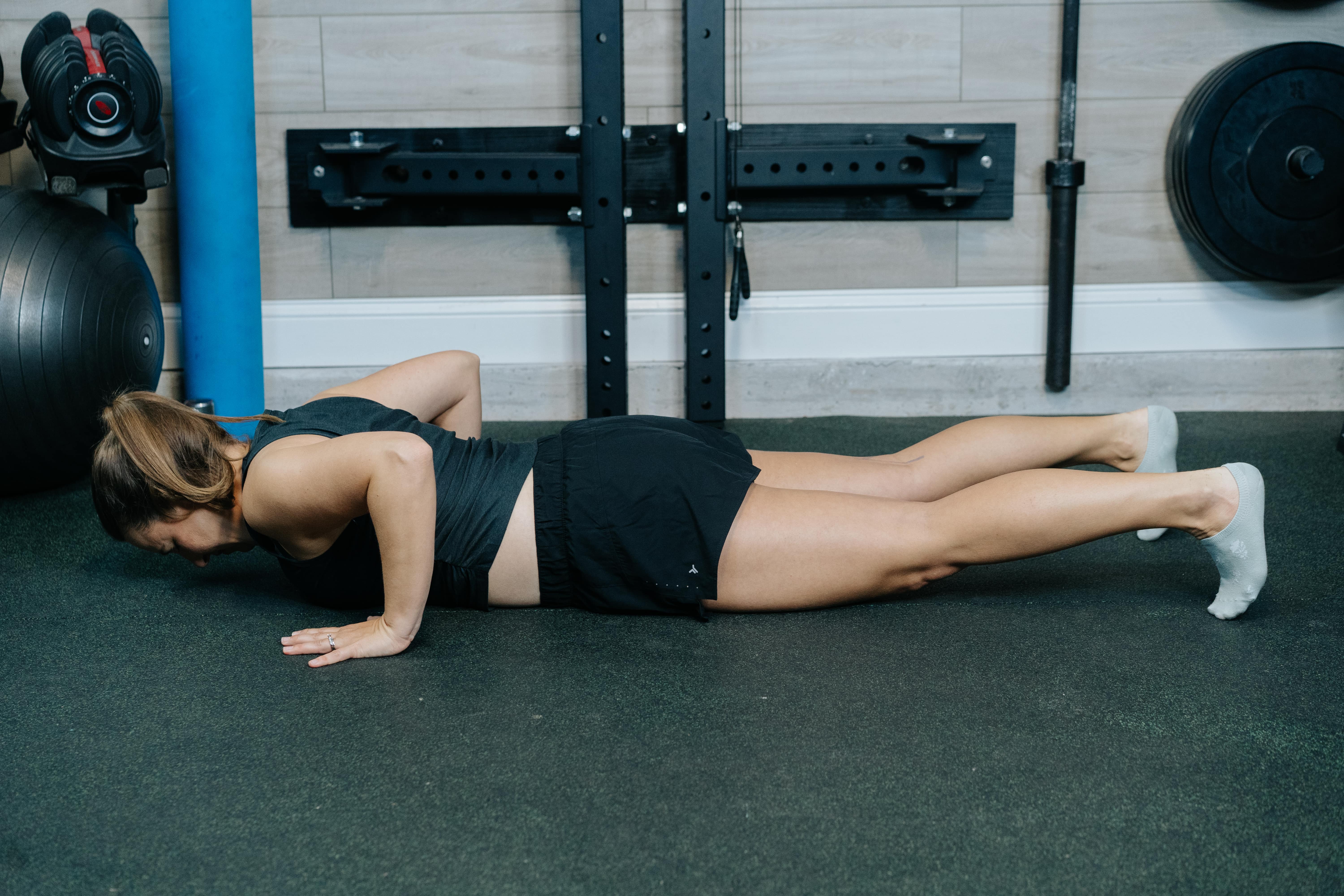 Women in the starting position for press up to downward dog