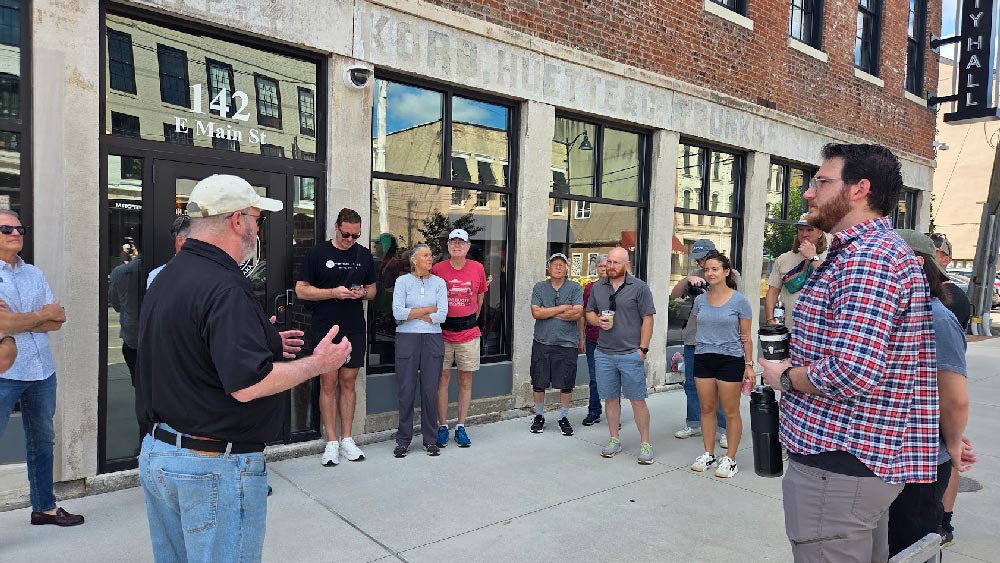 Director Scott Wood talking with perambulators in front of city hall