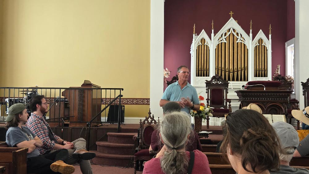 Jerry Finn discussing the history of the church inside one of it’s gathering areas