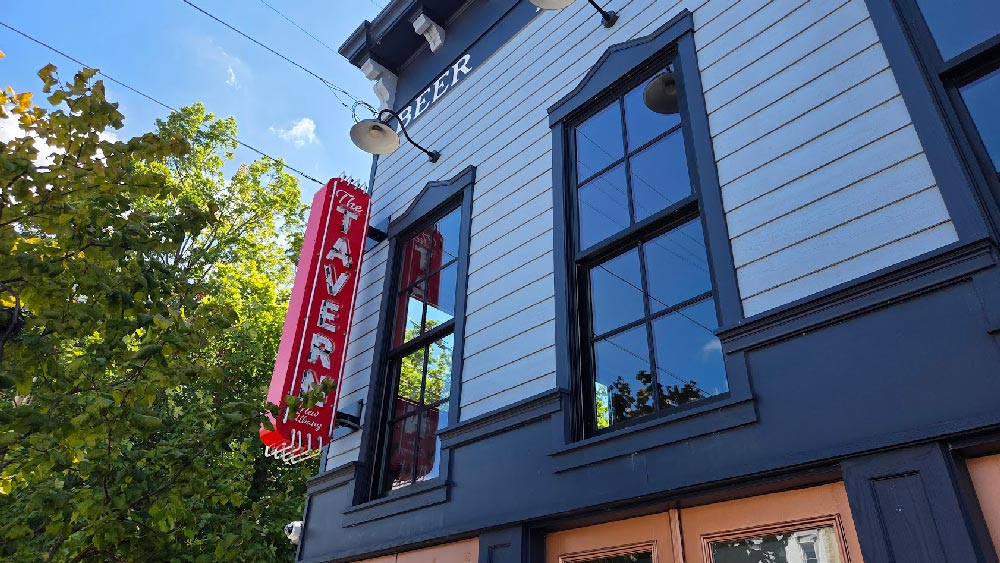 The front of the New Albany Tavern with a new sign