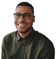 A cheerful man in glasses and a green shirt, showcasing a warm smile and inviting presence.