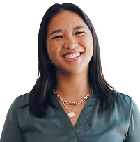 A woman smiling confidently, exuding positivity and self-assurance.