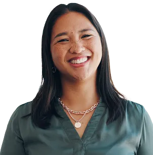 A woman smiling confidently, exuding positivity and self-assurance.