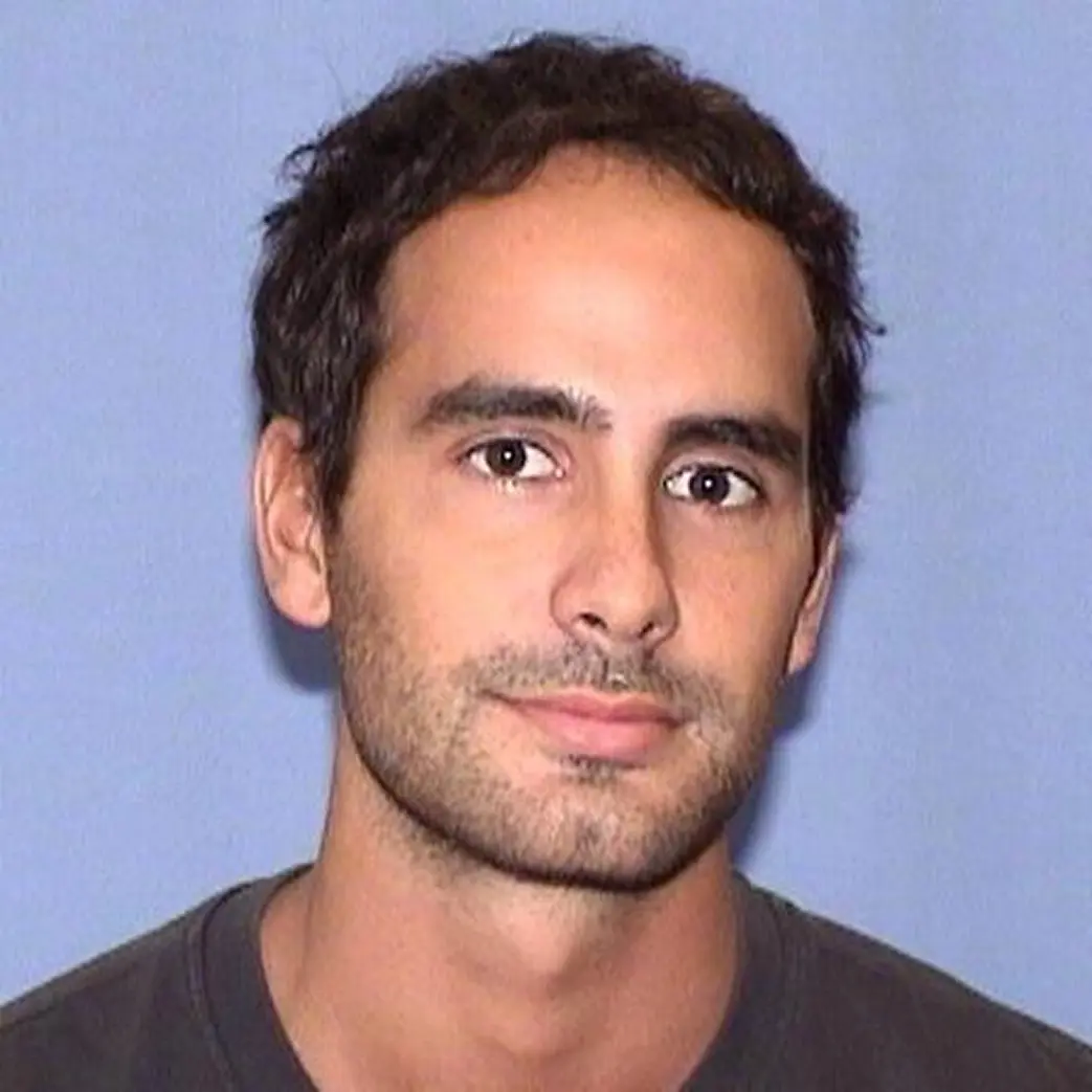 andrea in a grey t-shirt against a lavender background