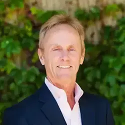 image of josh bersin against green leafy background, smiling