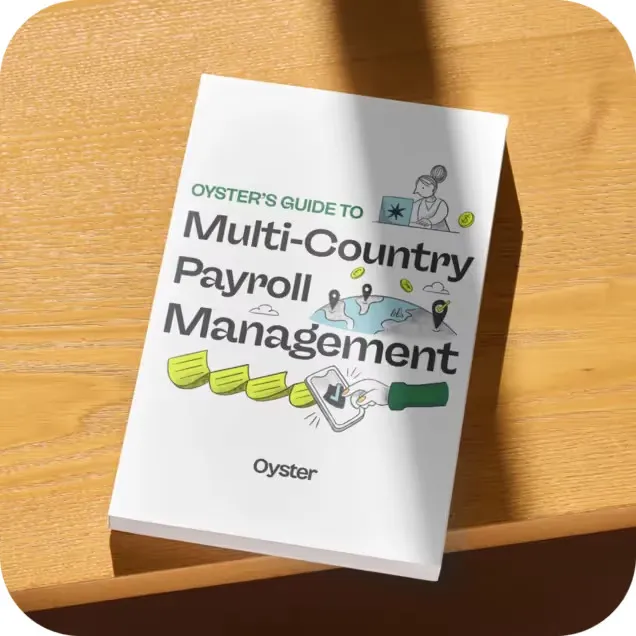 Book titled 'Oyster's Guide to Multi-Country Payroll Management' lying on a wooden surface with illustrations of a person and a world map.