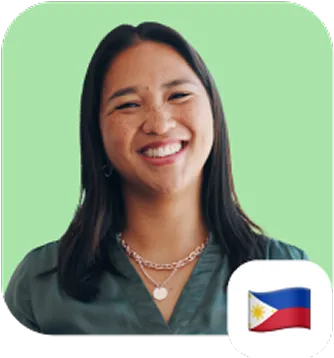 Smiling young woman with long dark hair wearing a green top and layered necklaces, set against a light green background, with a small Philippine flag icon in the corner.