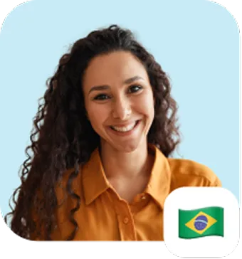 Smiling woman with long curly dark hair wearing a mustard yellow shirt against a light blue background, with a Brazilian flag icon in the bottom right corner.