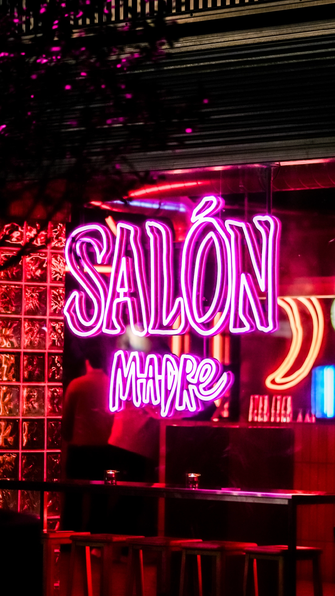 A purple neon light sign of the Salon Madre logo design created during the brand identity project by Sanna Studio