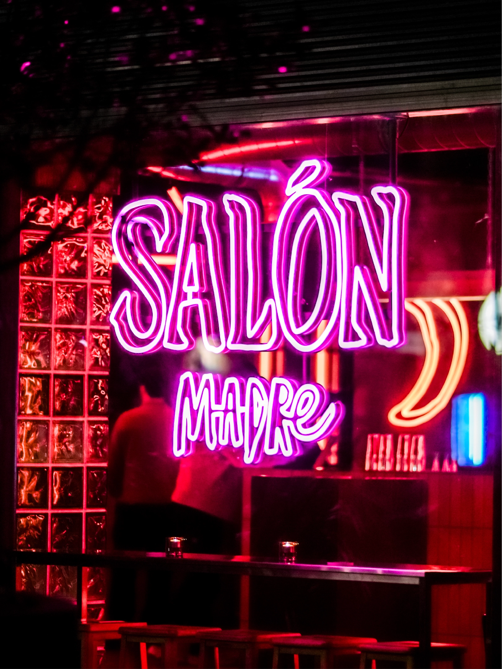 A purple neon light sign of the Salon Madre logo design created during the brand identity project by Sanna Studio