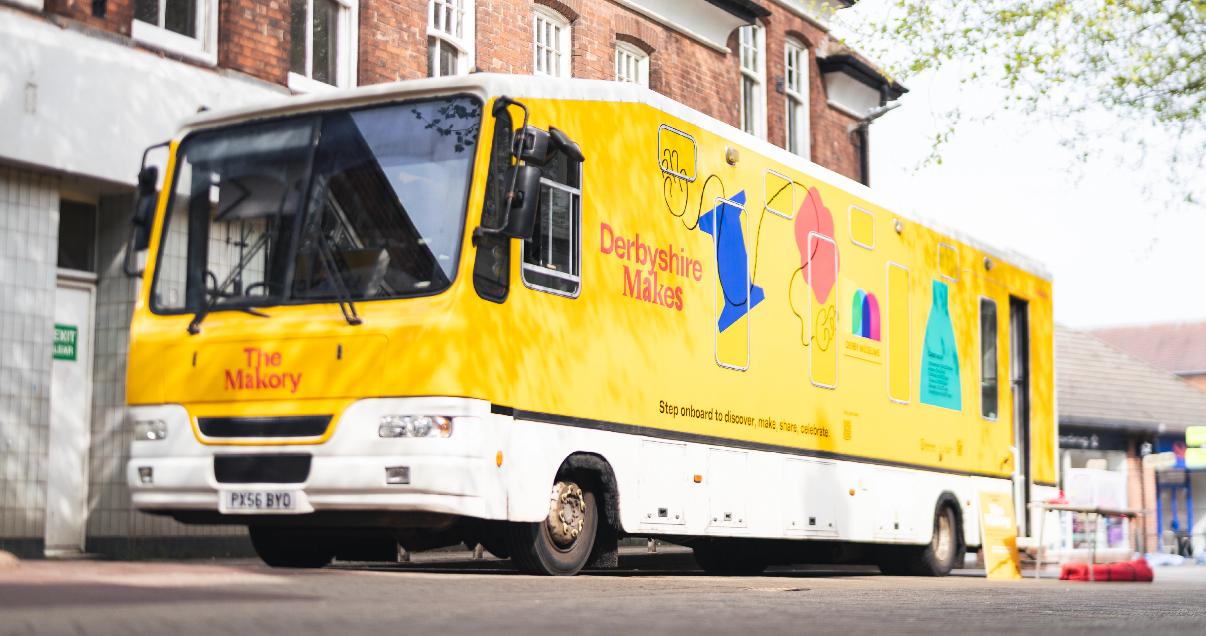 A photograph of the Derby Museums bus called The Makory wrapped with Derbyshire Makes branding advertising the festival and other events.