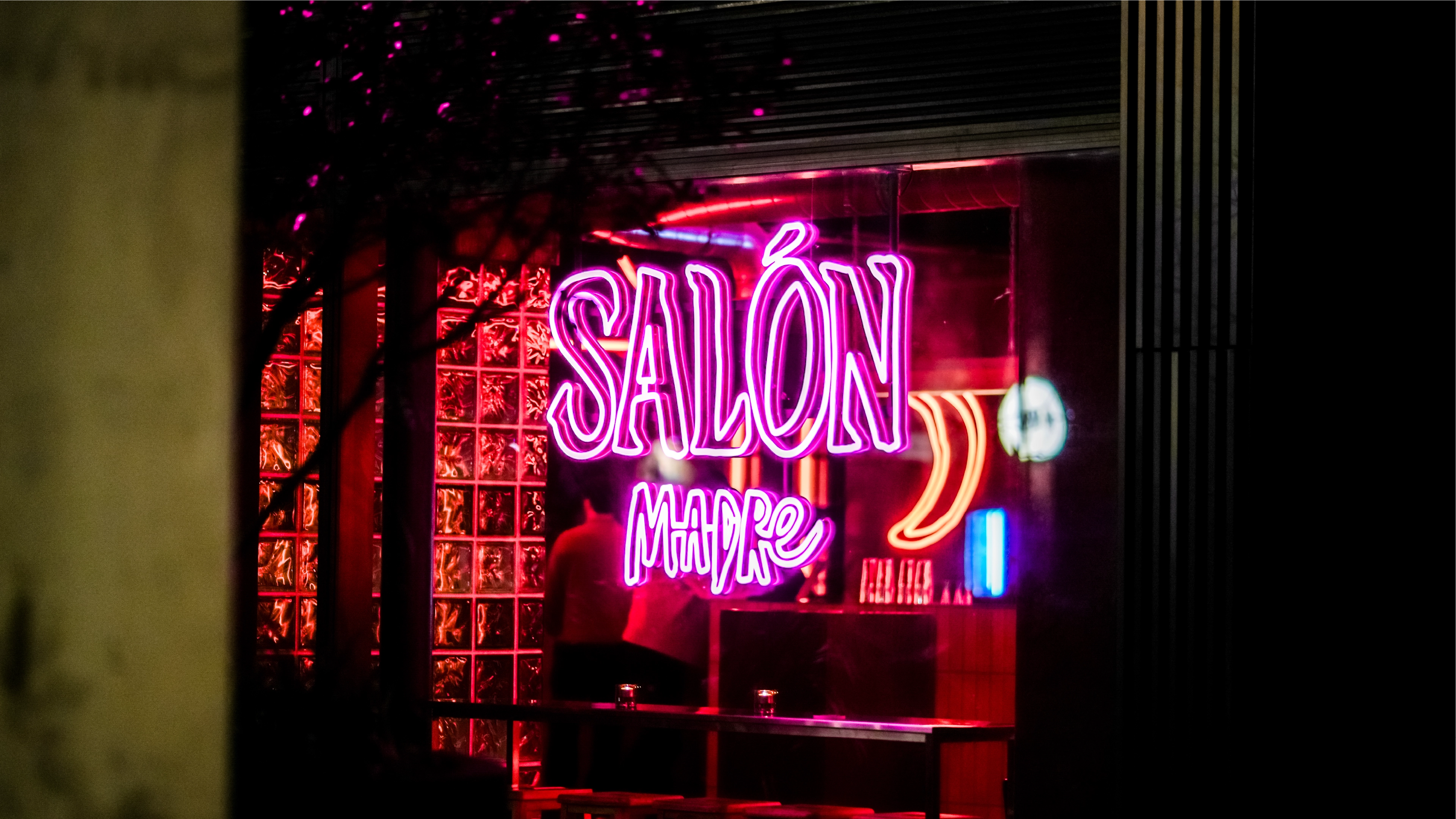 A purple neon light sign of the Salon Madre logo design created during the brand identity project by Sanna Studio